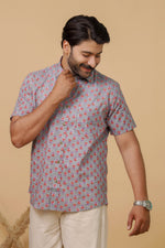 Load image into Gallery viewer, Man wearing a lavender floral printed half sleeve shirt with beige trousers against a beige background.