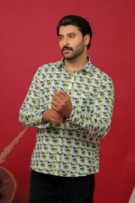 Load image into Gallery viewer, Man wearing a white horse printed full sleeve shirt with black jeans against a red background.