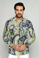 Load image into Gallery viewer, Man wearing a patterned shirt with a gray background