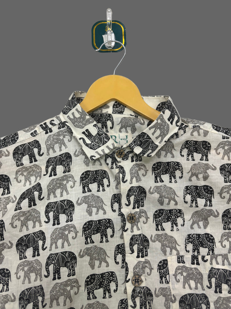 Fabric with elephant pattern on a hanger against a light background
