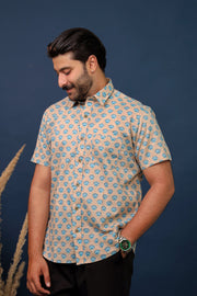 Men wearing beige and blue floral hand block printed cotton shirt with traditional Sanganeri print by Rangat Jaipur.