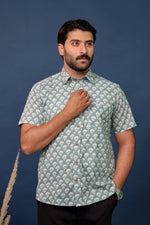 Load image into Gallery viewer, Men wearing sage green floral hand block printed cotton shirt with traditional Sanganeri print by Rangat Jaipur