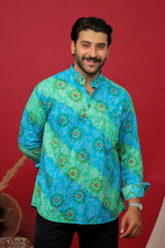 Load image into Gallery viewer, Man wearing a sky blue Bandhani printed kurta shirt with black jeans against a red background.