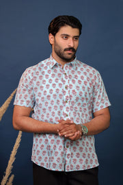 Men wearing sky blue floral hand block printed cotton shirt with traditional Sanganeri print by Rangat Jaipur.