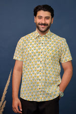 Load image into Gallery viewer, Men wearing yellow floral hand block printed cotton shirt with traditional Sanganeri print by Rangat Jaipur.